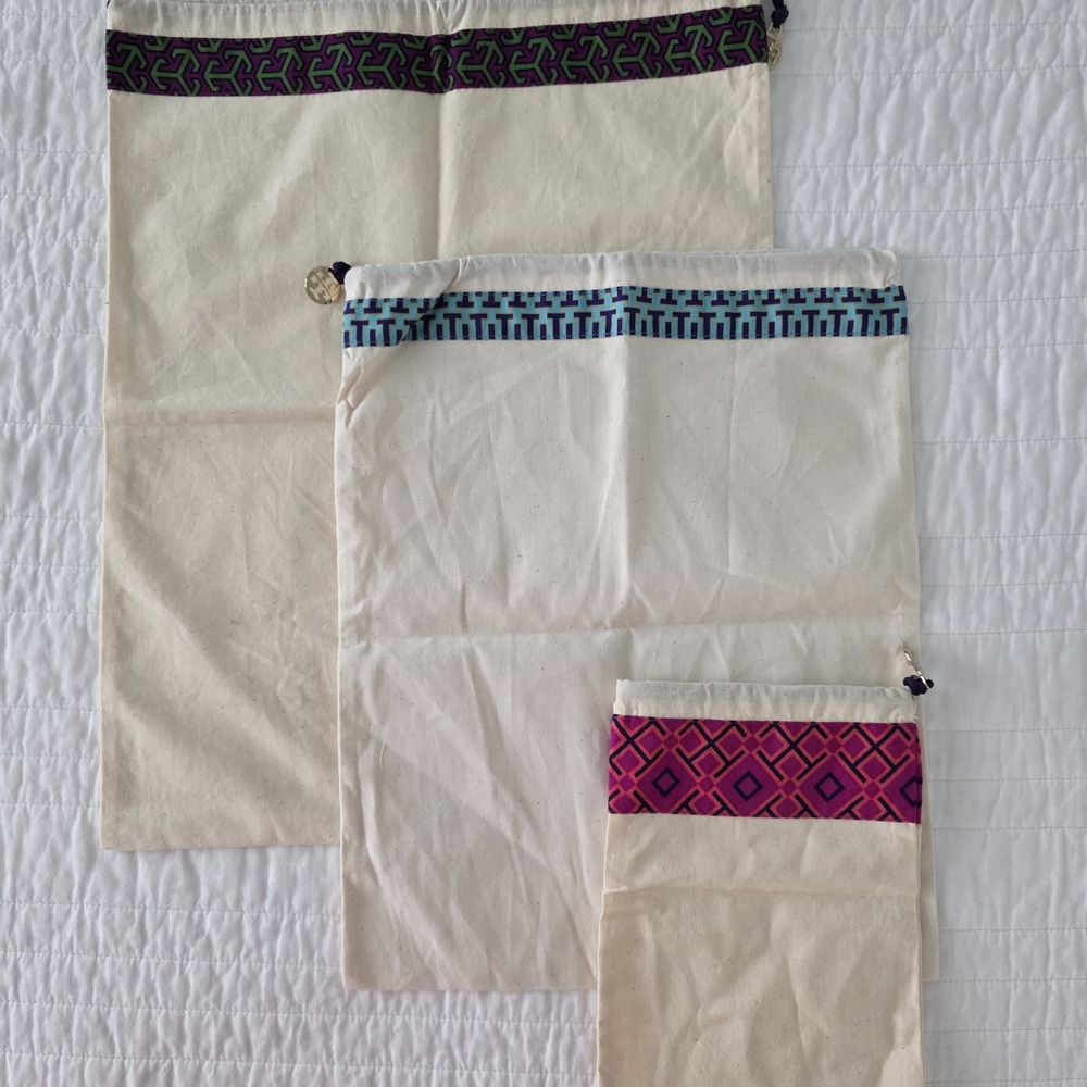 Tory Burch Set of Three Cream Drawstring Bags with Patterned Trim